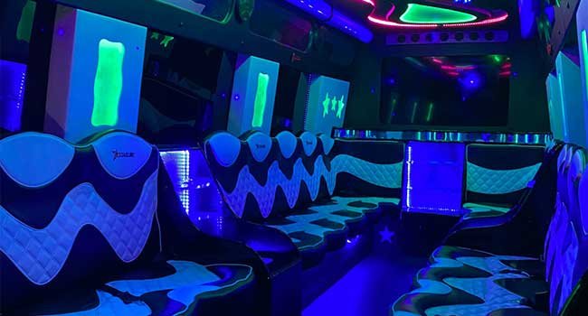 Purple-lit party van decorated with balloons