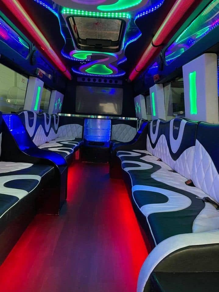 Wraparound seating under blue lights in a party van